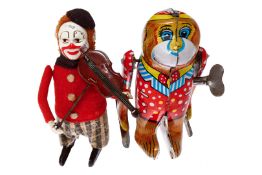 Schuco Tanzfigur, Clown, Uhrwerk intakt, tw LS und Alterungsspuren, H 11 cm, Z 3, dazu 1 Blech-