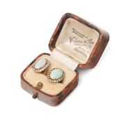 A pair of opal and white sapphire set earrings, the oval opals of approximately 10.7 by 6.5 by 2.6mm