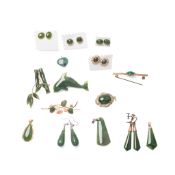 A group of nephrite set jewellery comprising a brooch in the form of a dolphin, a coral and nephrite