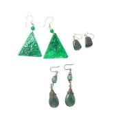 A pair of deep green jade drop earrings, the large triangular drops engraved to one side, together