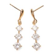 A pair of 9ct gold and cubic zirconia drop earrings of thee graduated oval cut stones below teardrop