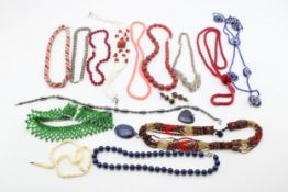 A group of glass and hardstone beaded necklaces, including a garnet necklace with silver crab-claw