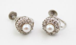 A pair of 9ct white gold, diamond and pearl flower head cluster form earrings, each pearl of