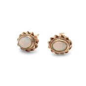 A pair of opal set earrings, the oval opals of approximately 6.2 by 4.7mm, in rope twist and flounce