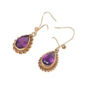 A pair of 9ct gold and amethyst drop earrings, the rope twist setting with deep violet pear cut