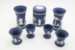 Wedgwood Cobalt Blue Jasperware to include a lidded circular jar, a pair of vases, 11.5cm tall, a