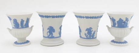A pair of Wedgwood Blue on White Jasperware trumpet vases, 8.5cm tall, with a pair of small urns,