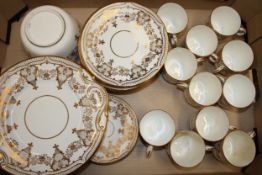 An Edwardian part tea service to include eleven cups, twelve saucers, twelve side plates, a sugar