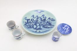 A collection of oriental ceramics to include a cup and saucer, two cups and a large charger (5).
