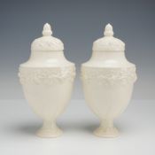 Pair of Wedgwood Embossed Queen's Ware Footed Urns with Lids