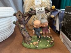 OLD COUPLE SWINGING FROM TREE ORNAMENT
