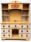 Tri-Ang Wooden Shop Cabinet, a 1950s toy cabinet with roller shutter, 2 glass windows and 13 small