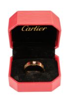 A Cartier style 18ct gold ring - set with three round brilliant cut diamonds and interspersed with