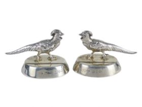 A pair of menu holders - Chester 1912, modelled in the form of pheasants mounted on oval bases,