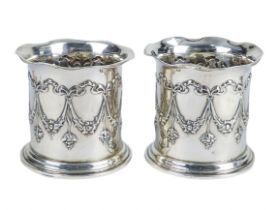 A pair of silver perfume bottle holders - Chester 1906, cylindrical repousse decorated with swags,
