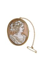A cameo brooch set within a 15ct gold frame - oval and carved with the bust of an elegant lady, 10.