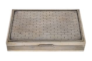 A white metal cigarette box - of rectangular form with a brick engraved hinged cover enclosing a