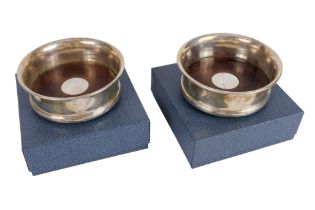 A pair of silver mounted bottle coasters - London 2001, Baybrook & Britten, of plain form with