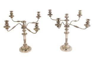 A matched pair of silver plated candelabra - the slender baluster support with leaf castings and