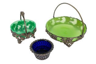 A silver plated swing handle basket - circular with a green glass liner, pierced decoration with