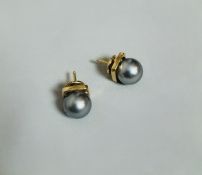 Paire de boucles d’oreilles clous en or jaune 18 carats 750 millièmes retenant chacune une perle noi