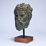Bronze bust of a statesman, with a bearded face and curly hair, mounted on a wooden pedestal.