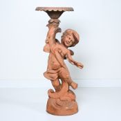 Cast iron garden ornament in the shape of a standing putto with birdbath