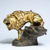 Thomas François CARTIER (1879-1936), sculpture of a gilded bronze lion on a rock, signed