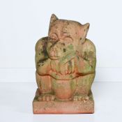 Terracotta garden statue of a sitting troll with a beautiful weathered appearance
