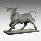 Large cast iron garden statue of a bull on a pedestal