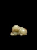 A SMALL CELADON AND RUSSETT CARVING, China, Qing dynasty, 18th/19th century