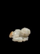 A WHITE JADE AND RUSSET FIGURE OF LIONS, China, Qing dynasty, 18th century