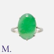 A Jade Ring set with an oval cabochon of jade. Band unmarked; tests indicate 9ct gold. Size: K1/2