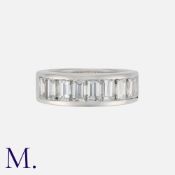 A Diamond Half Eternity Ring in white gold, set with a row of nine step cut diamonds totalling