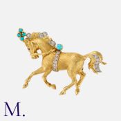 BEN ROSENFELD, A Horse Brooch in 18 carat yellow gold, designed as a horse, set with cabochon