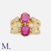 An Antique Ruby and Diamond Ring set with two oval-cut rubies (untested; strong red fluorescence