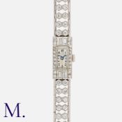 An Diamond Cocktail Watch in platinum, the dial with Arabic numeral indices, minute track and