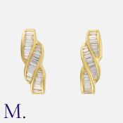 A Pair of Baguette Cut Diamond Earrings in 18 carat yellow gold, set with baguette cut diamonds