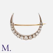 An Antique Diamond Crescent in yellow gold and silver, set with old cut diamonds weighing approx.