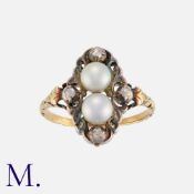 An Antique Pearl and Diamond Ring in yellow gold and silver, set with two grey pearls and four old