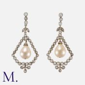 A Pair of Natural Saltwater Pearl and Diamond Drop Earrings in yellow gold and silver. Each