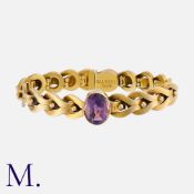 An Antique Amethyst Bracelet in 15K gold, set with an oval cut amethyst to the centre (approx. 13.