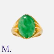 A Jade Ring in yellow gold, set with a jade cabochon. Chinese marks to the inside of the band