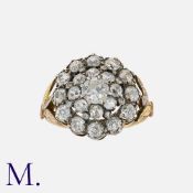 An Old Cut Diamond Cluster Ring in 18 carat yellow gold and silver, comprising a principal old cut