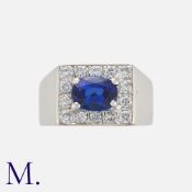 A Sapphire and Diamond Ring in 14 carat white gold, set with an oval cut sapphire of approximately