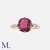 A Rhodolite Garnet and Diamond Ring in yellow gold, set with a cushion shaped rhodolite garnet of