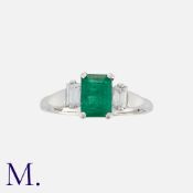 An Emerald and Diamond Ring, in 18 carat gold, set with a central step cut emerald of