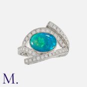 An Opal and Diamond Ring set with a cabochon opal with strong blue and green colours, together