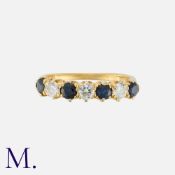 A Sapphire and Diamond Ring in yellow gold, set with four round cut sapphires and three round