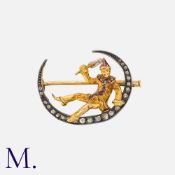 An Antique Harlequin Brooch in yellow gold and silver, comprising a recumbent figure resting on a